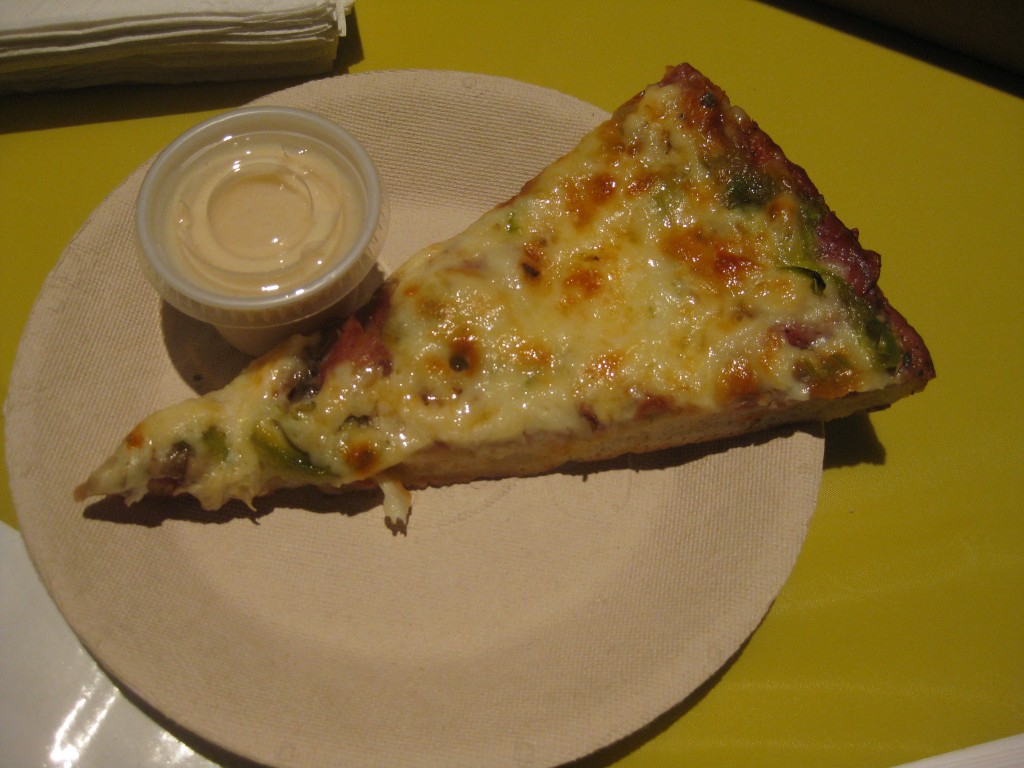 Slice of combination pizza and donair sauce from Acropole.